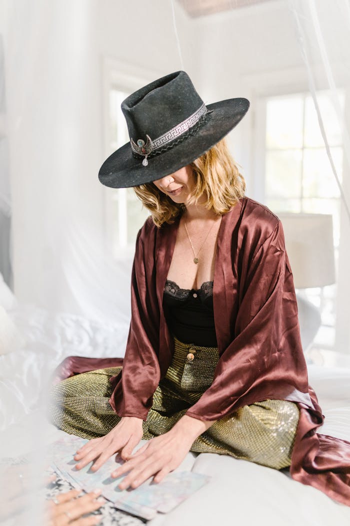 Stylish woman reading tarot cards in a bright room, embracing serenity and mysticism.